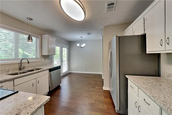 a kitchen with a sink and a refrigerator