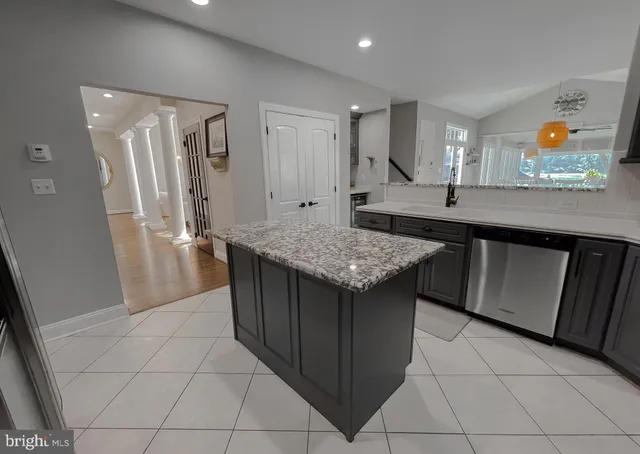 a living room with furniture a fireplace and a large window
