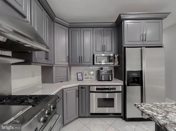 a living room with furniture flat screen tv and a large window