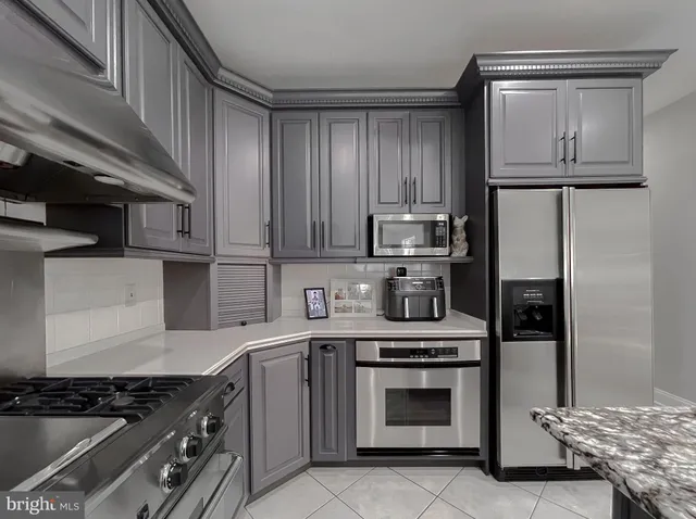 a living room with furniture flat screen tv and a large window