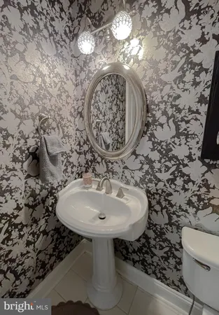 a bedroom with furniture a flat screen tv and a fireplace