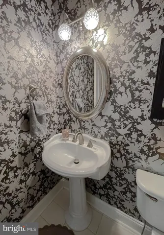 a bedroom with furniture a flat screen tv and a fireplace