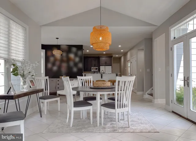 a view of a hallway with wooden floor and a chandelier