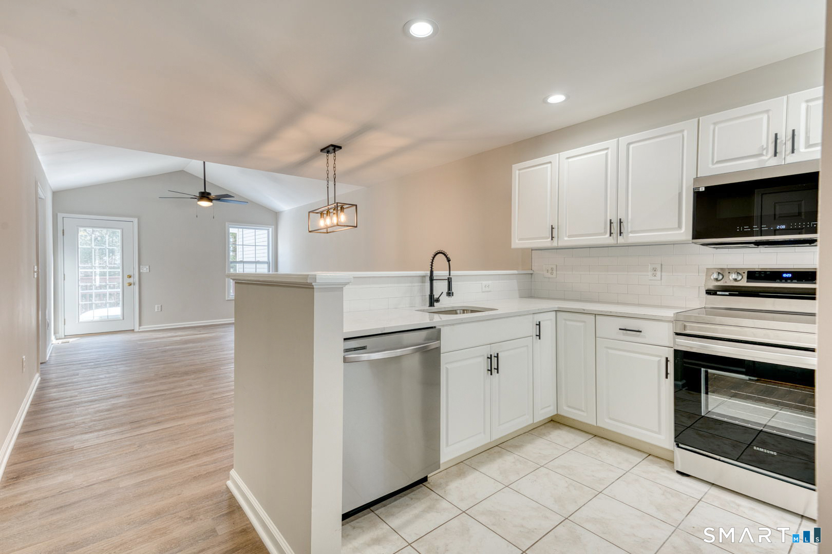 159 Jennifer Lane, Unit 159 Newtown, CT 06482 - Photo 11 of 28 a kitchen with cabinets stainless steel appliances and a counter space