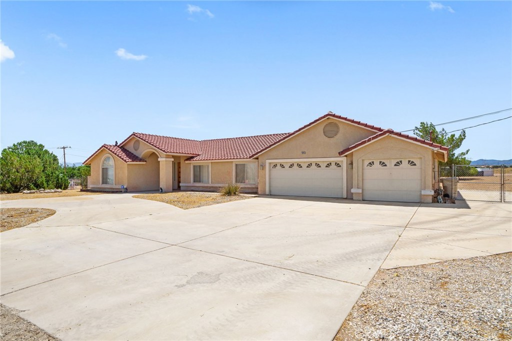 13045 Ranchero Road Oak Hills, CA 92344 - Photo 1 of 1 a view of residential houses with road
