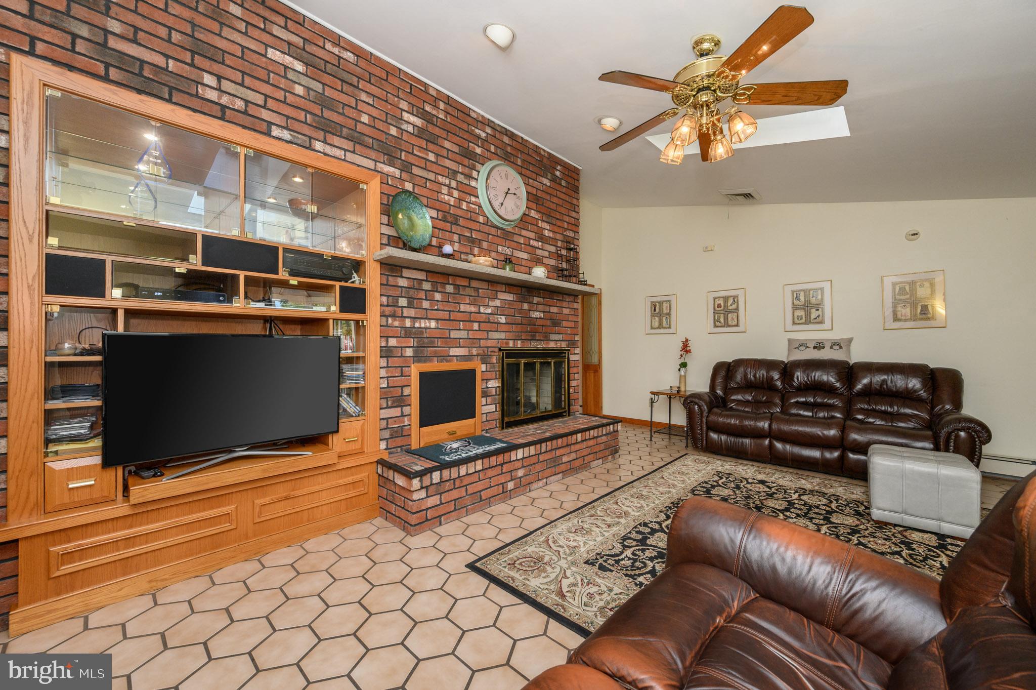 1404 Columbus Road Burlington, NJ 08016 - Photo 15 of 55 a living room with furniture a flat screen tv and a fireplace