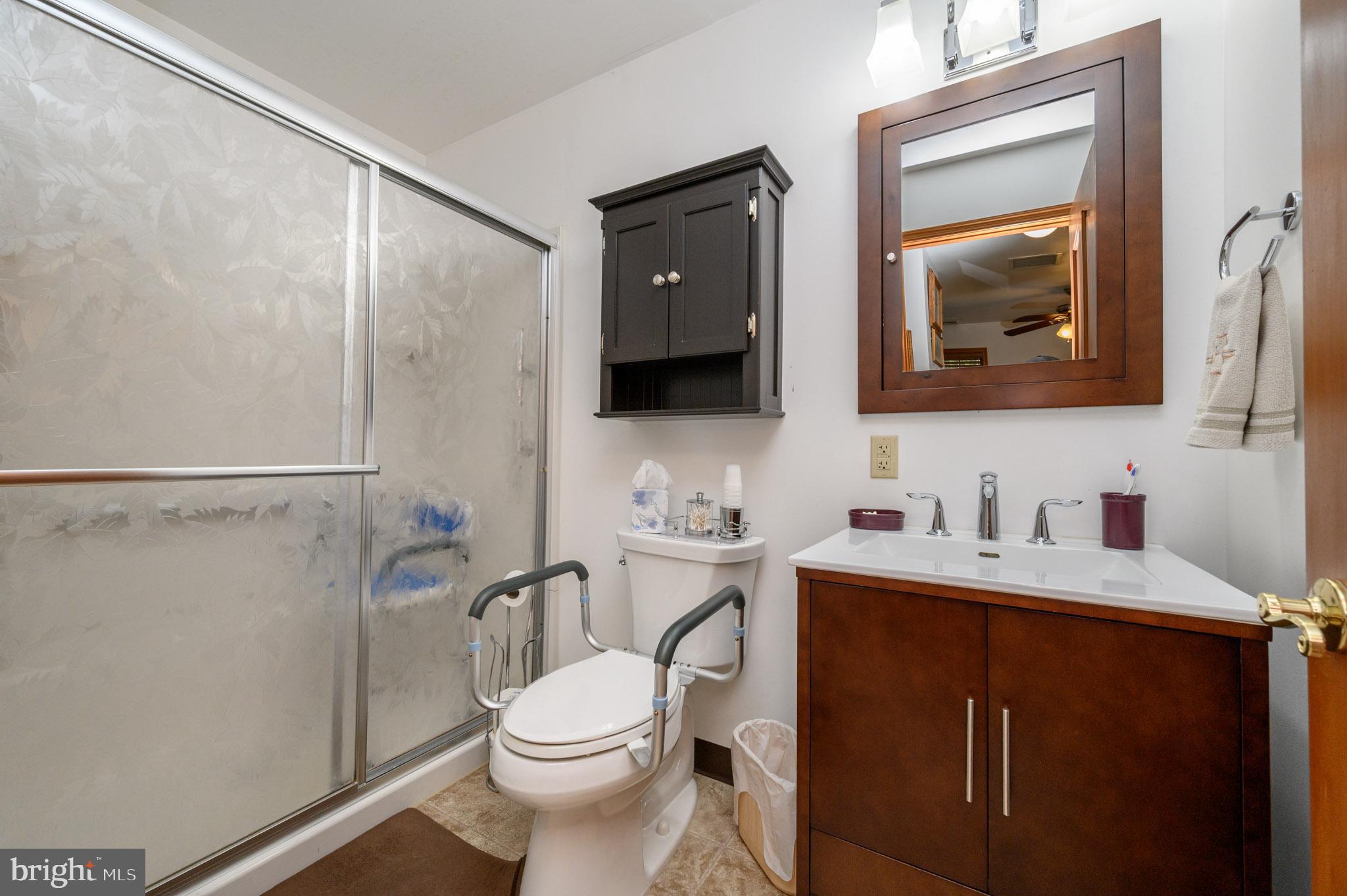 1404 Columbus Road Burlington, NJ 08016 - Photo 36 of 55 a bathroom with a toilet a sink a vanity and mirror