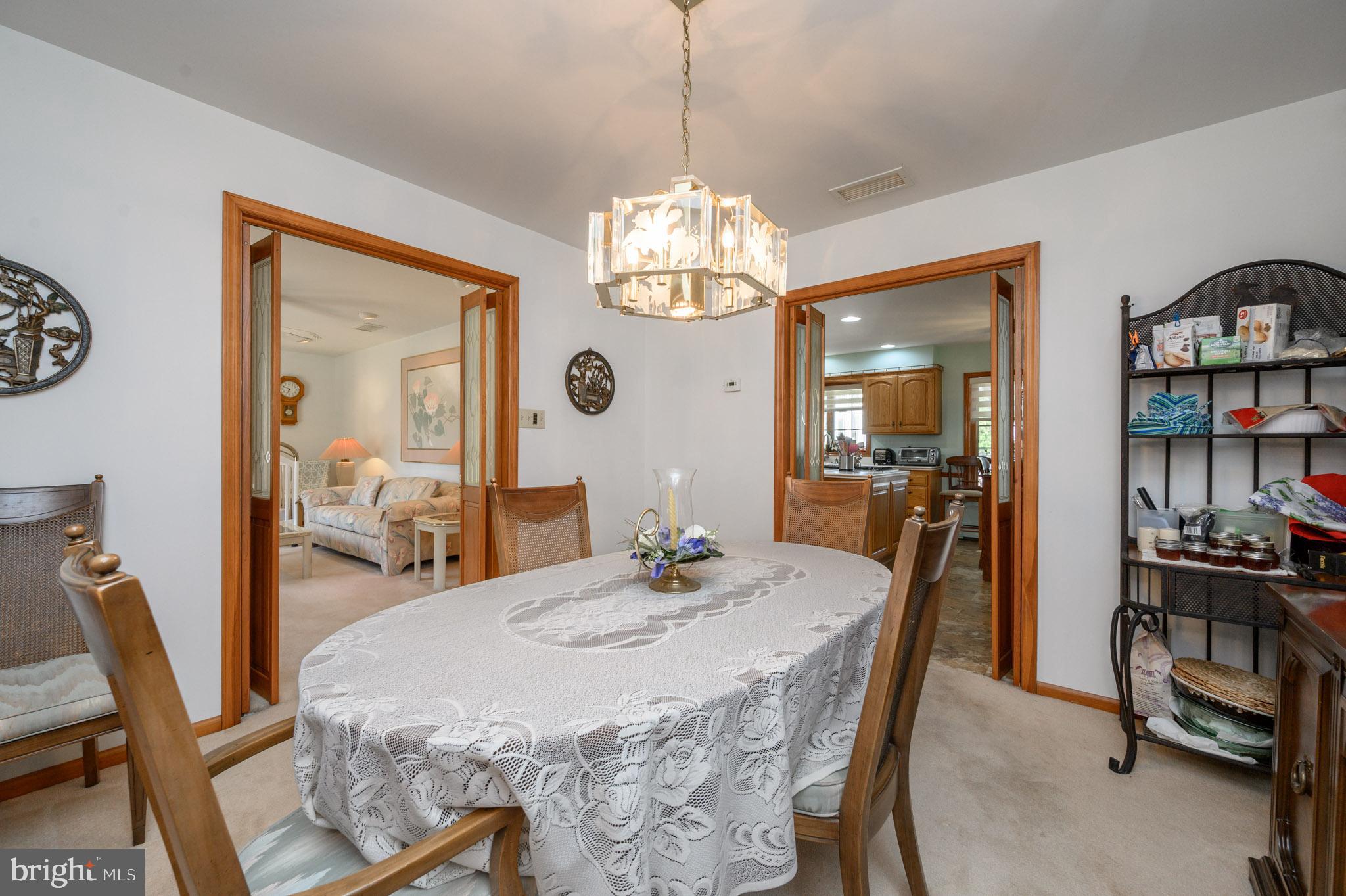 1404 Columbus Road Burlington, NJ 08016 - Photo 7 of 55 a dining room with furniture a rug and a chandelier