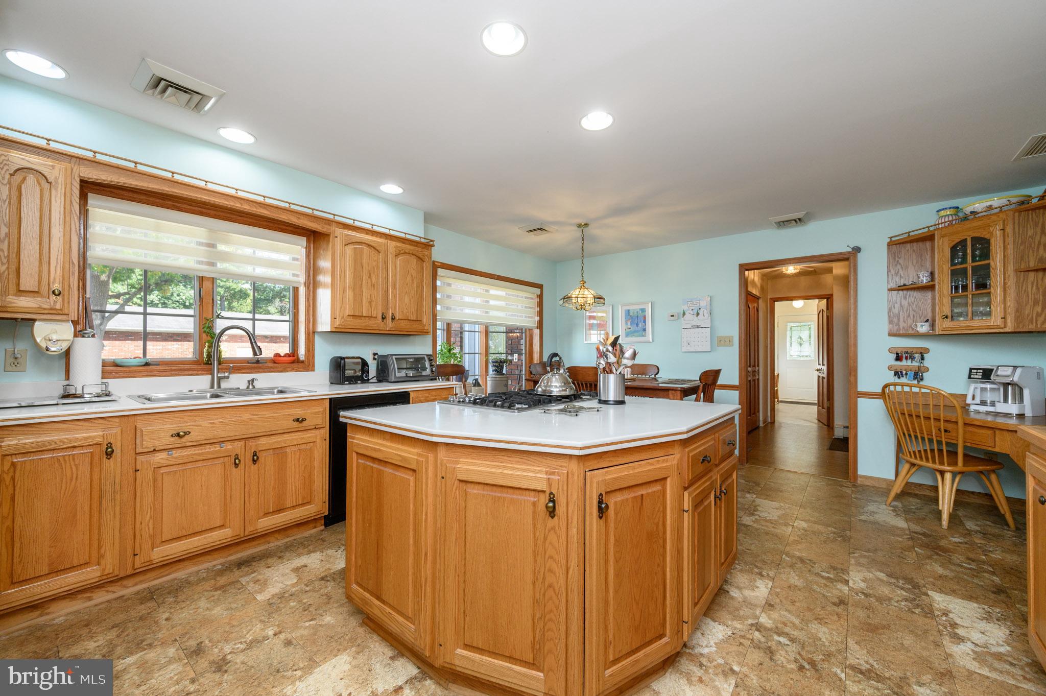 1404 Columbus Road Burlington, NJ 08016 - Photo 8 of 55 a kitchen with cabinets a sink and chairs in it