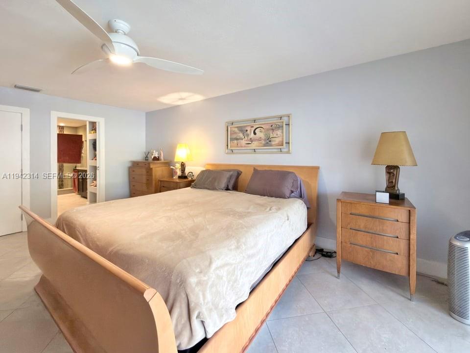 205 Bonnie Brae Way, Unit 33 Hollywood, FL 33021 - Photo 20 of 43 a bedroom with a bed and a chandelier