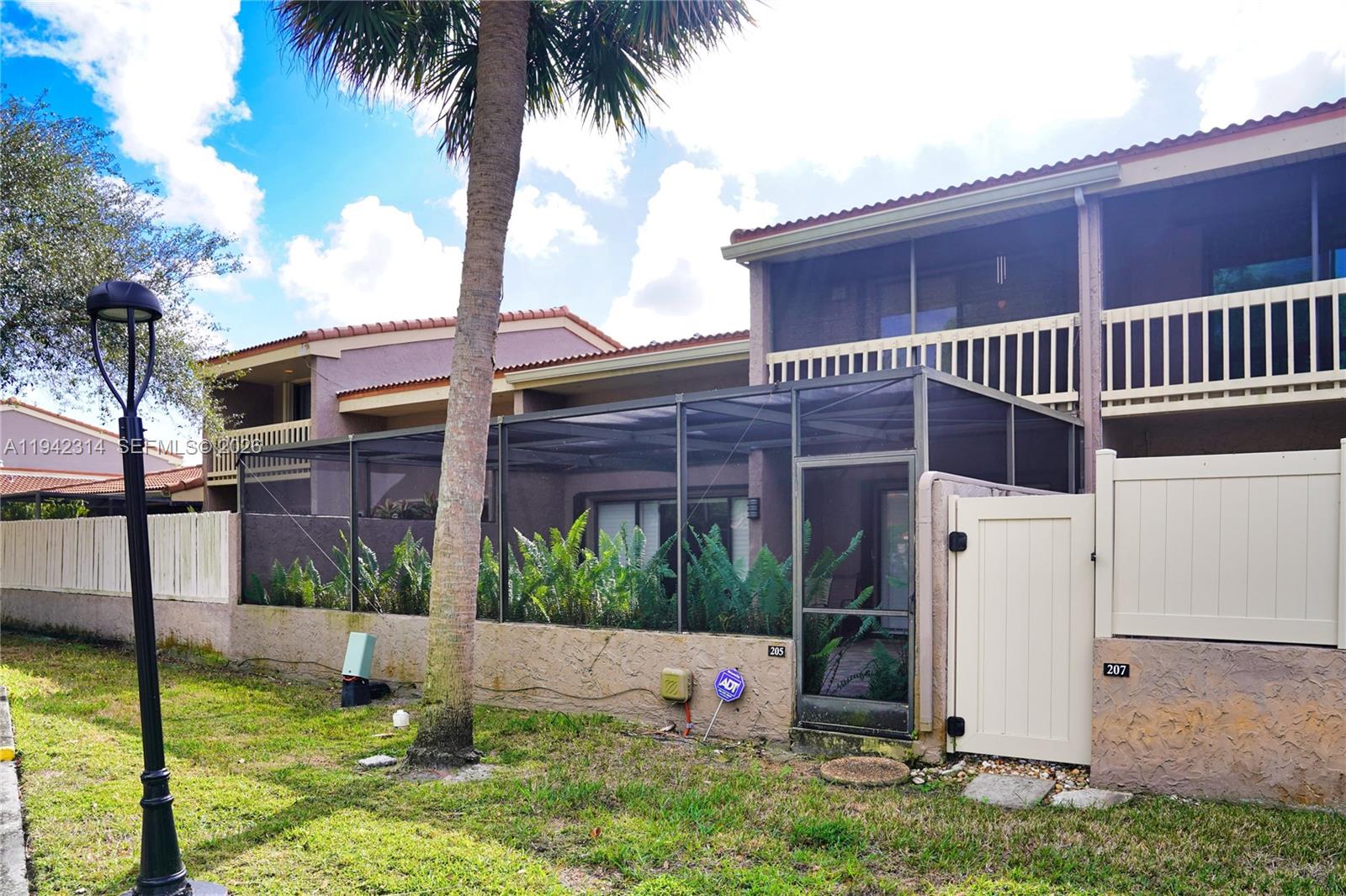 205 Bonnie Brae Way, Unit 33 Hollywood, FL 33021 - Photo 32 of 43 a view of a house with a yard and potted plants