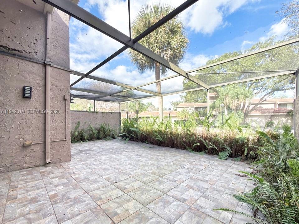 205 Bonnie Brae Way, Unit 33 Hollywood, FL 33021 - Photo 34 of 43 a view of a backyard with plants and brick walls