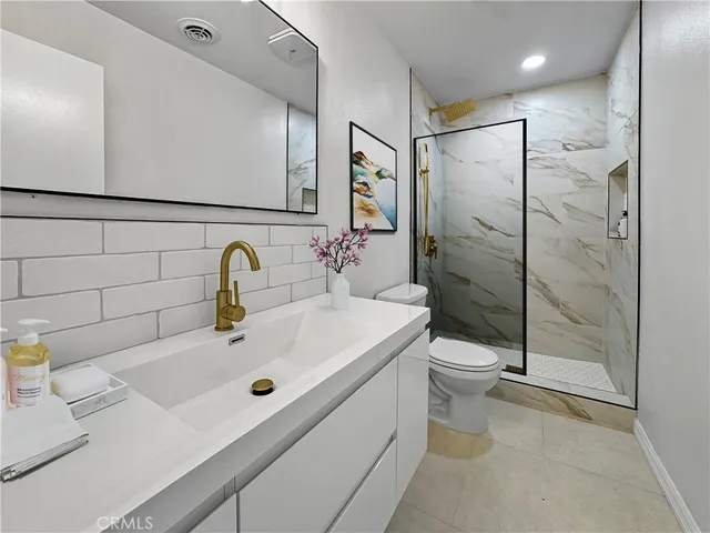 a bathroom with a sink toilet and shower