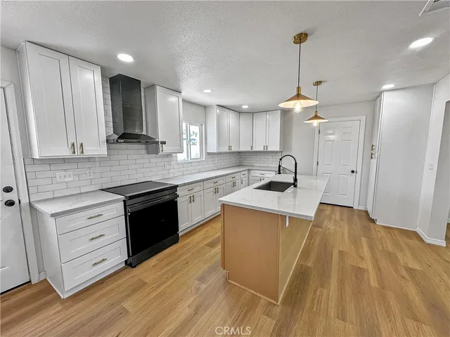 a kitchen with a sink appliances and cabinets