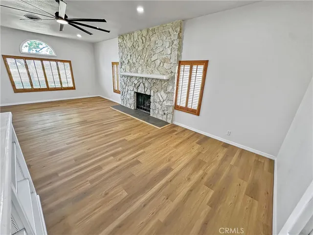 wooden floor in an empty room with a fireplace