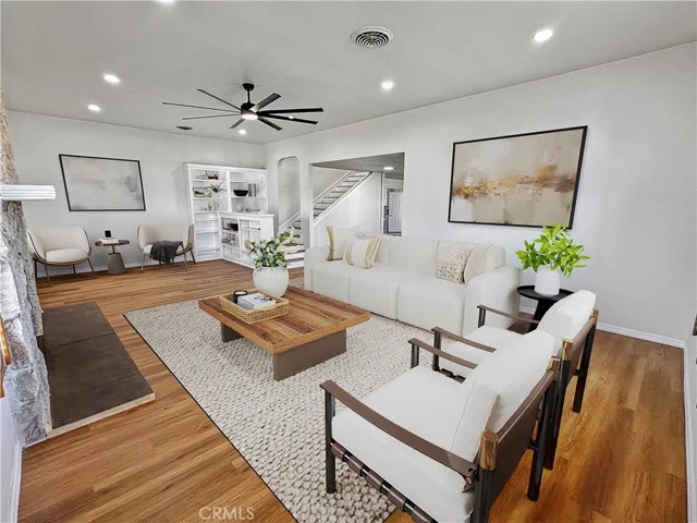 a living room with furniture and a potted plant
