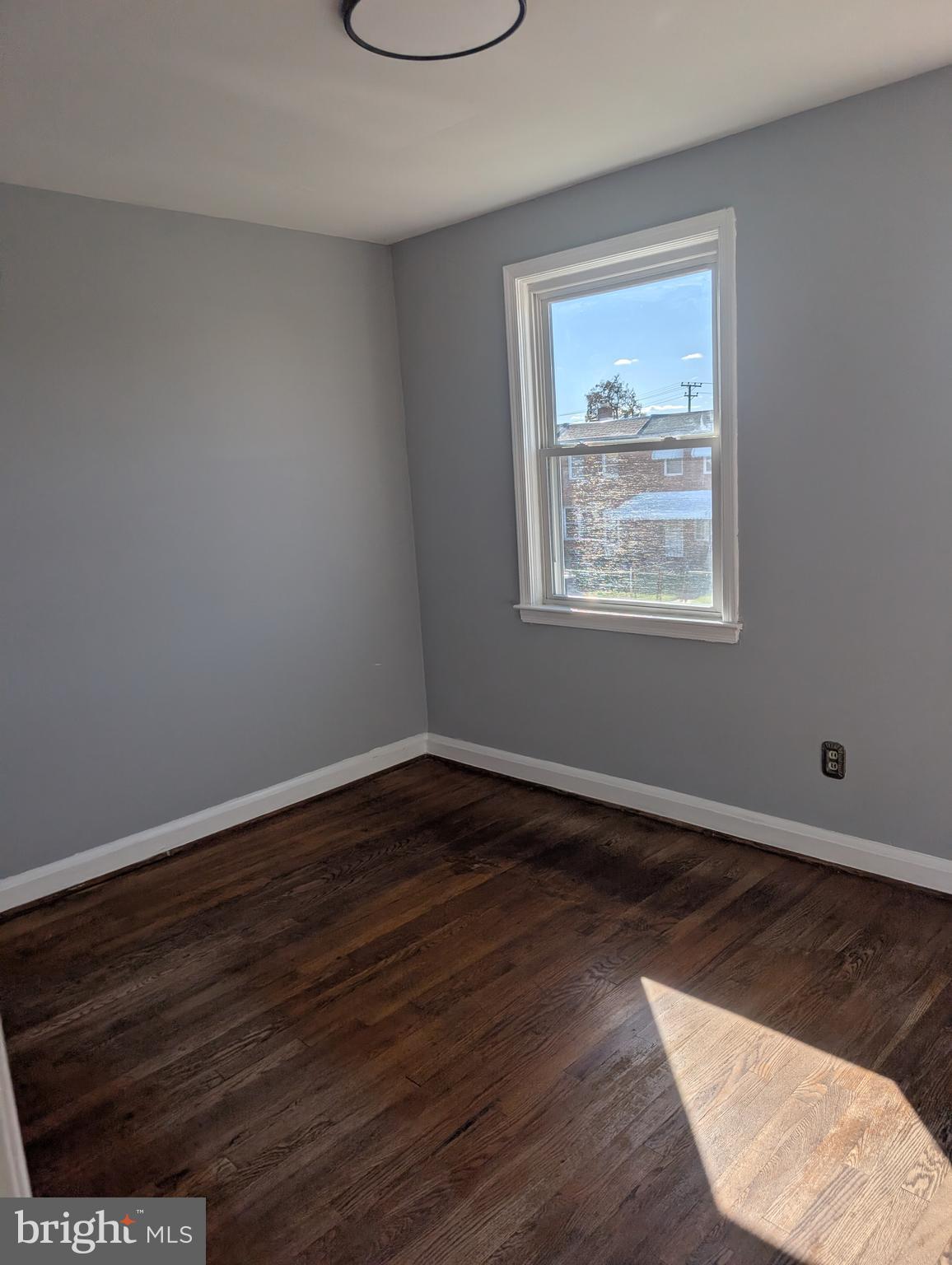 3011 Larue Square East Baltimore, MD 21225 - Photo 18 of 19 an empty room with wooden floor and windows
