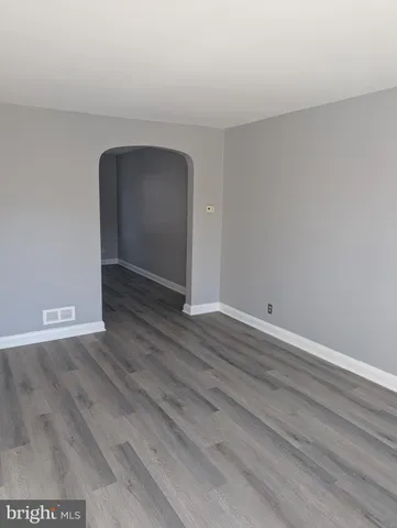 a view of an empty room and wooden floor
