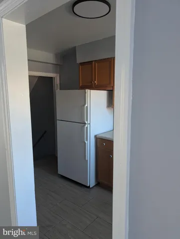 a view of a room with wooden floor and a sink