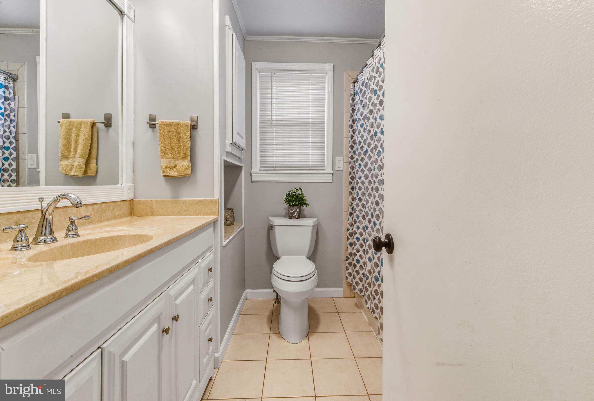 30 St Charles Place Runnemede, NJ 08078 - Photo 15 of 21 a bathroom with a granite countertop toilet a sink and a mirror