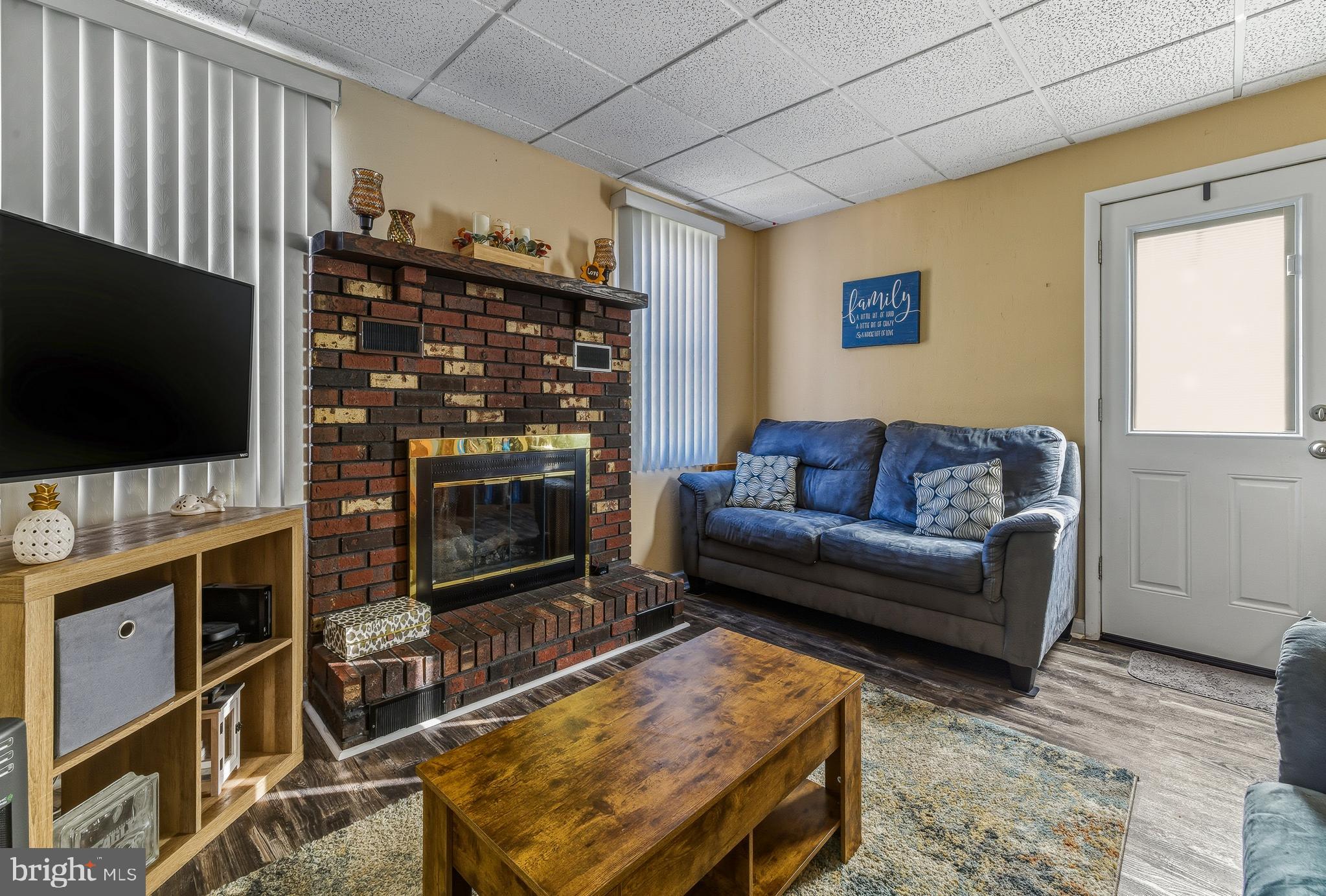 30 St Charles Place Runnemede, NJ 08078 - Photo 9 of 21 a living room with furniture a flat screen tv and a fireplace