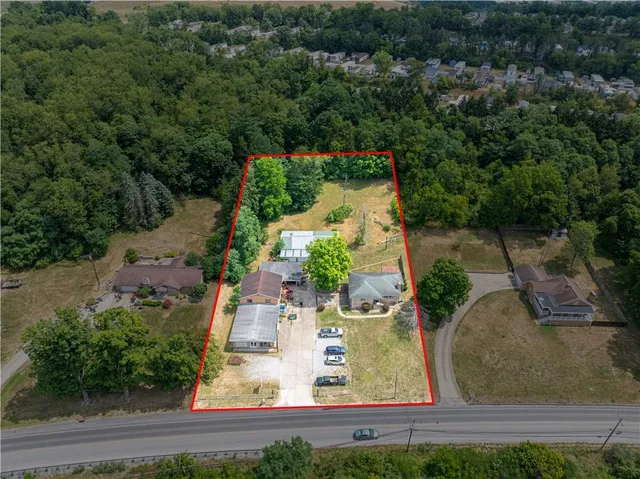 an aerial view of a house with a yard and lake view