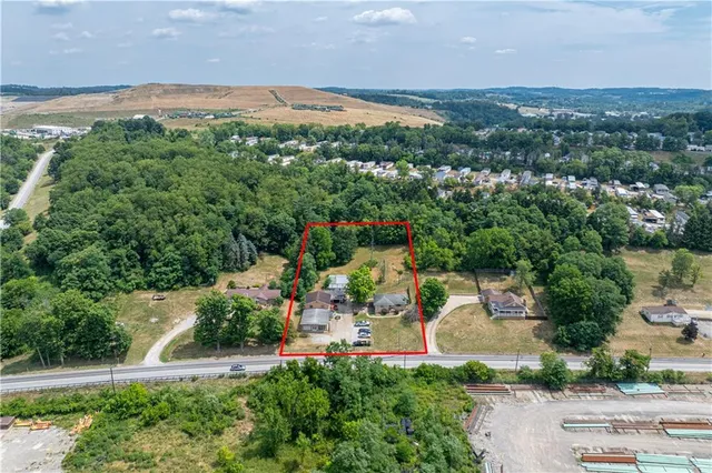 an aerial view of a houses with a yard