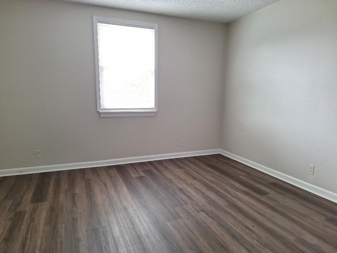 1005 Forest Ridge Court Hermitage, TN 37076 - Photo 7 of 9 a view of an empty room with wooden floor and a window