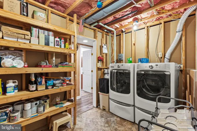 a utility room with multiple dryer and washer