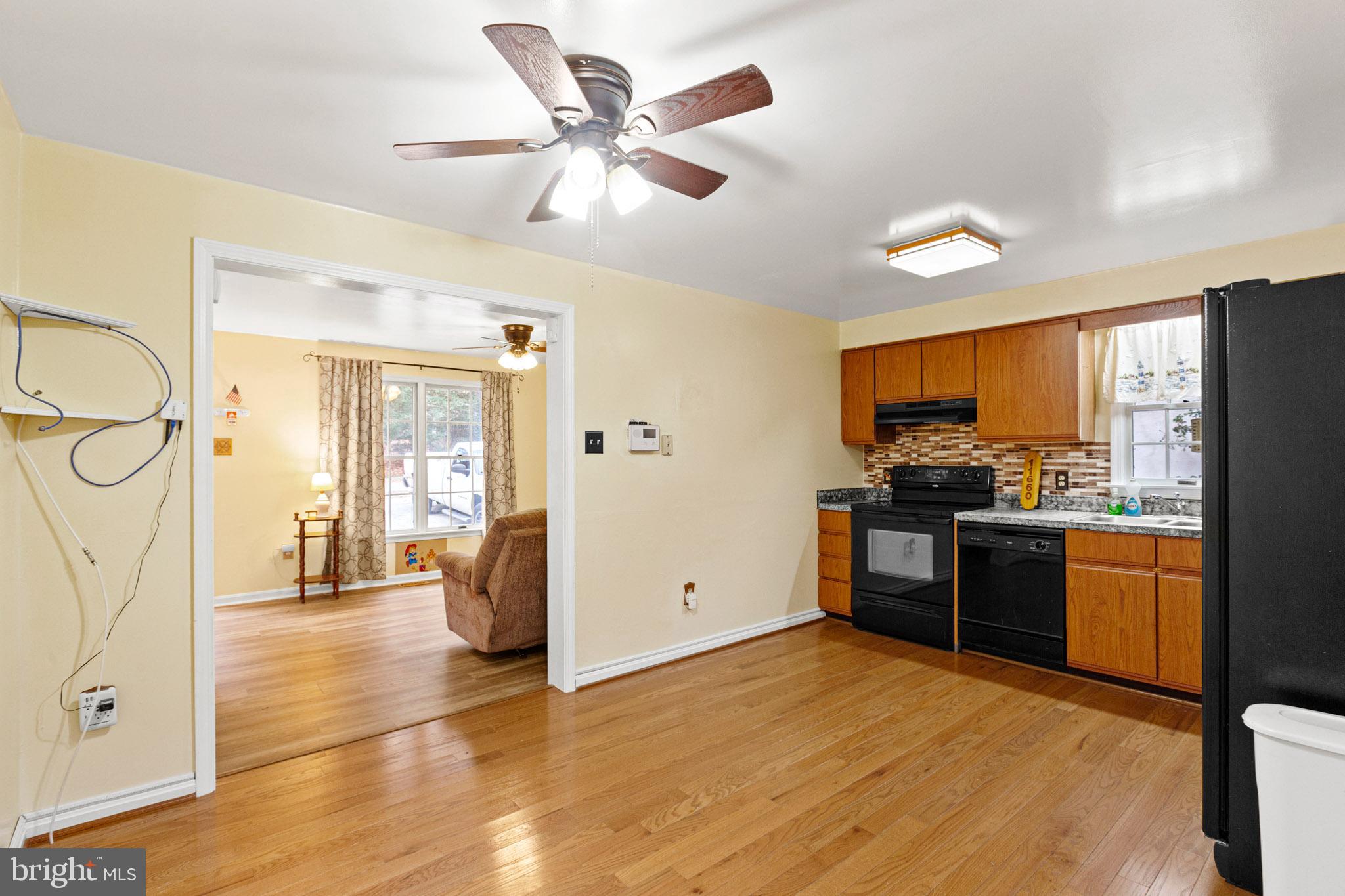 11660 Big Sandy Run Road Lusby, MD 20657 - Photo 5 of 30 a kitchen with stainless steel appliances granite countertop a refrigerator and a stove top oven