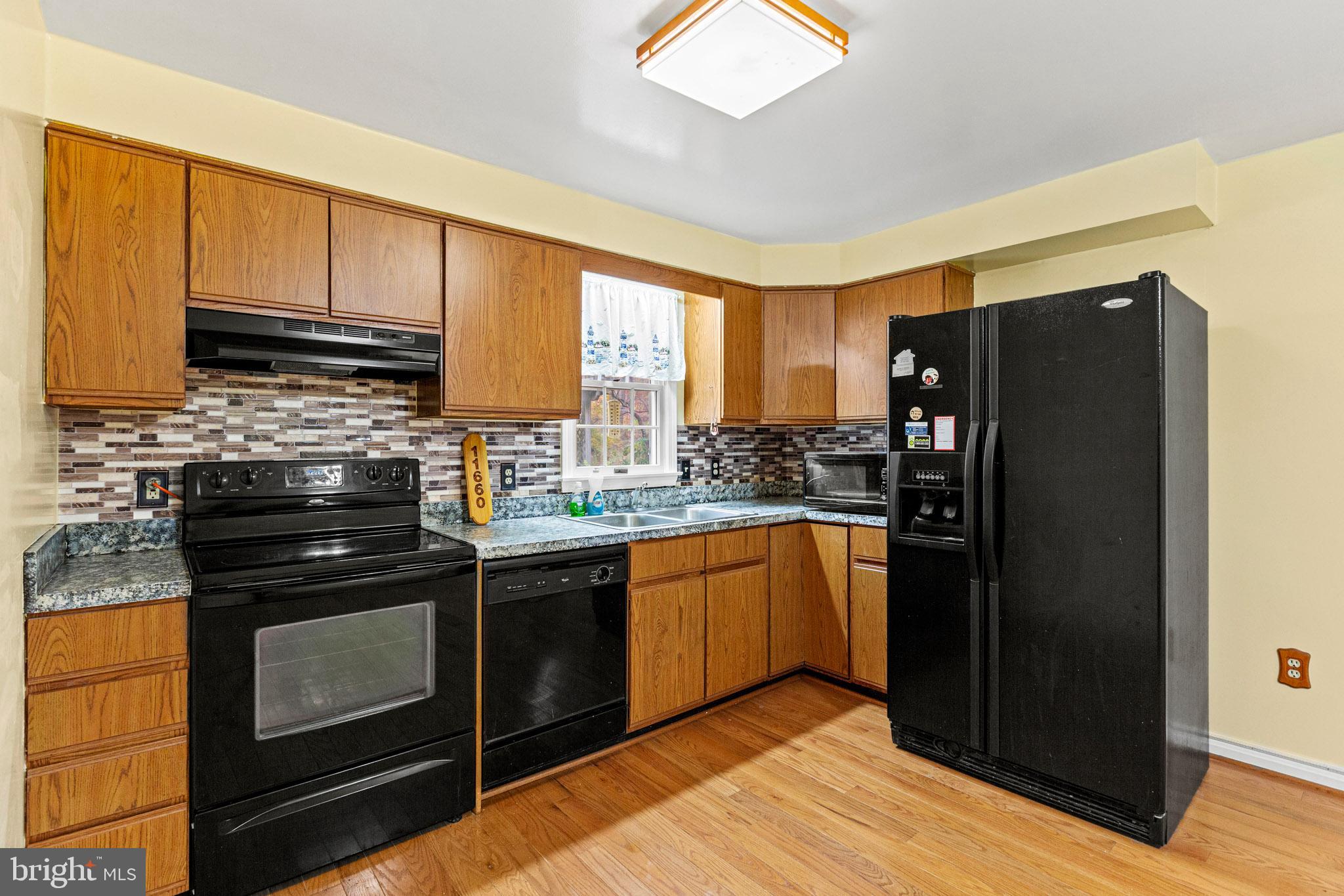 11660 Big Sandy Run Road Lusby, MD 20657 - Photo 6 of 30 a kitchen with stainless steel appliances granite countertop a refrigerator stove and sink