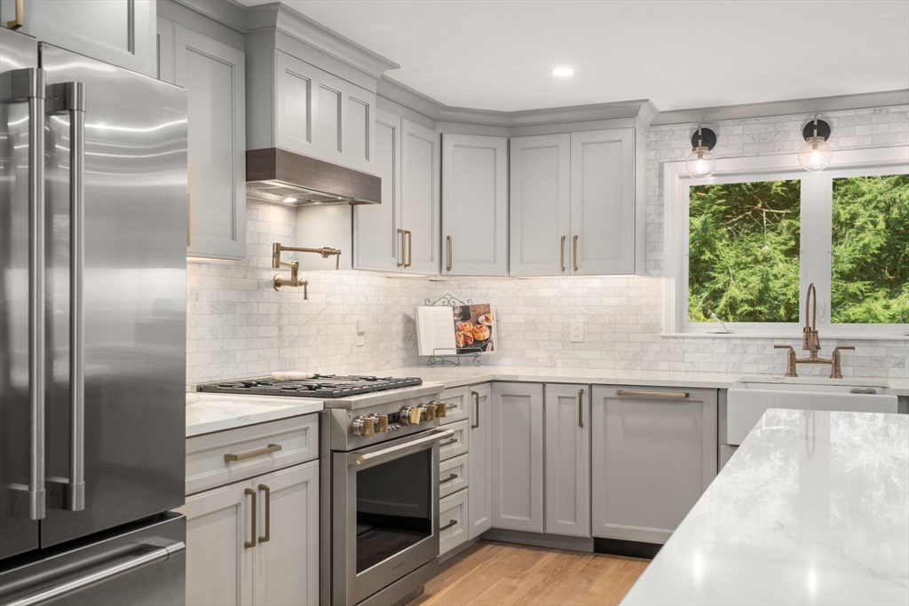 4 Highgate Road Wayland, MA 01778 - Photo 2 of 30 a kitchen with stainless steel appliances granite countertop a sink stove and refrigerator