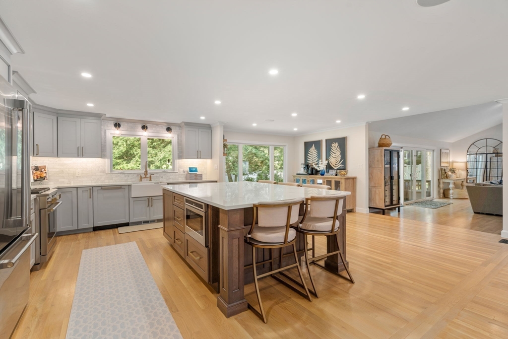 4 Highgate Road Wayland, MA 01778 - Photo 4 of 30 a kitchen with kitchen island a table and chairs in it