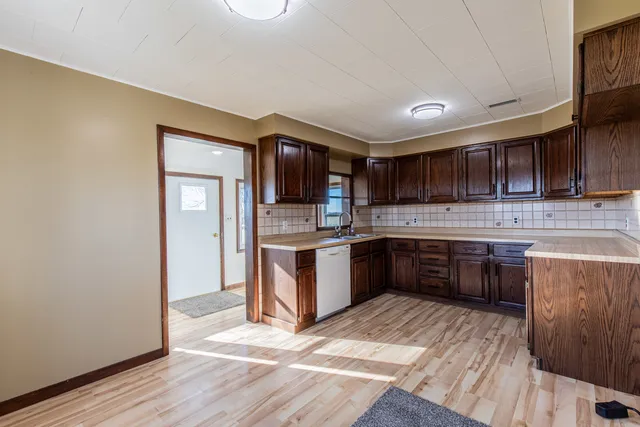 a bathroom with a granite countertop toilet and a sink
