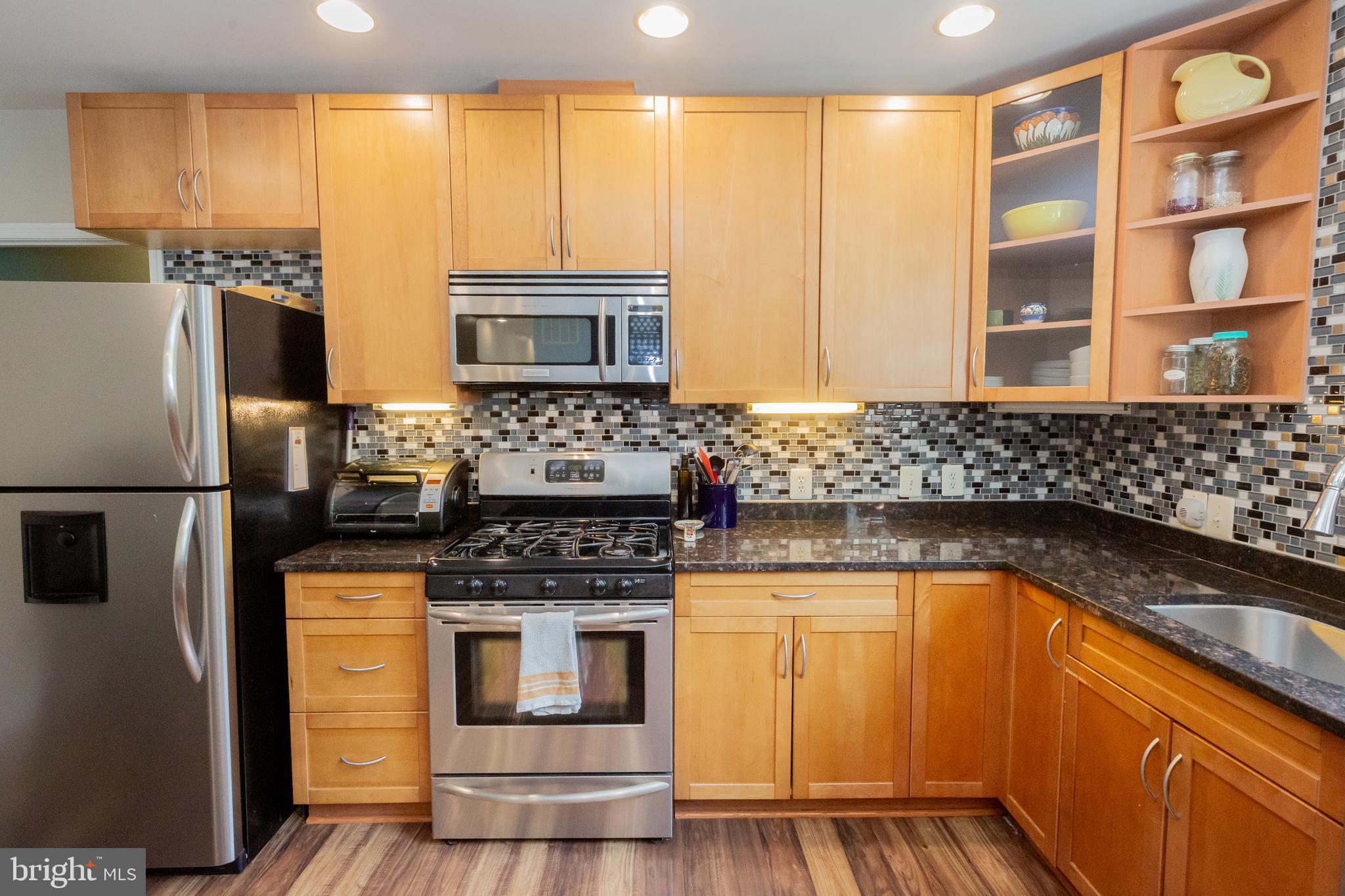 423 18th Street Northeast, Unit 12 Washington, DC 20002 - Photo 11 of 41 a kitchen with stainless steel appliances granite countertop a stove a sink and a refrigerator