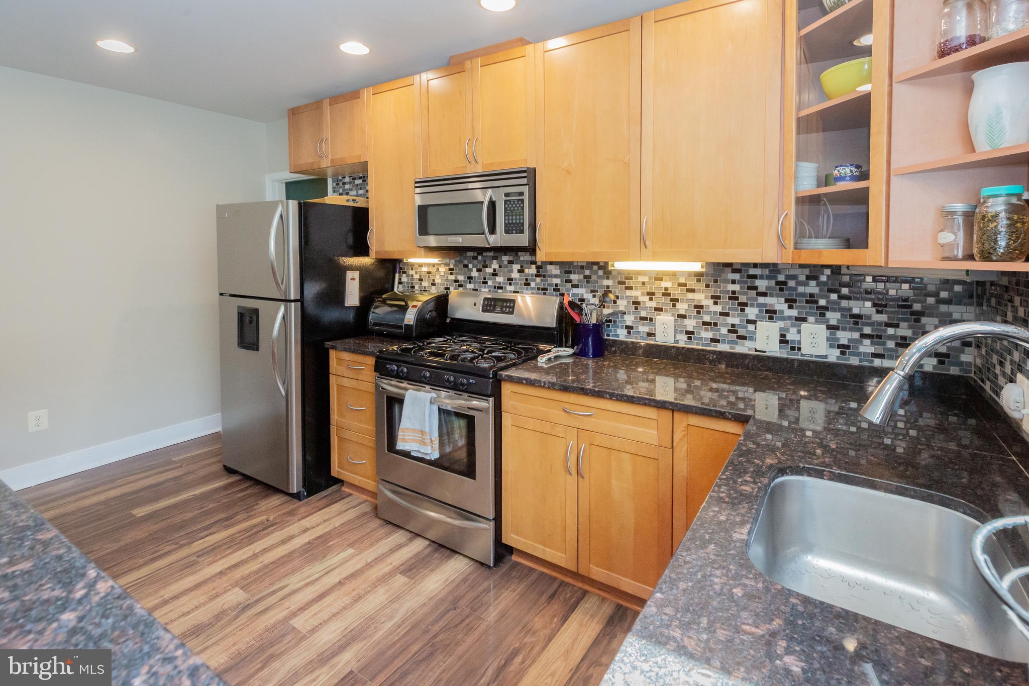 423 18th Street Northeast, Unit 12 Washington, DC 20002 - Photo 13 of 41 a kitchen with stainless steel appliances granite countertop a sink stove and refrigerator