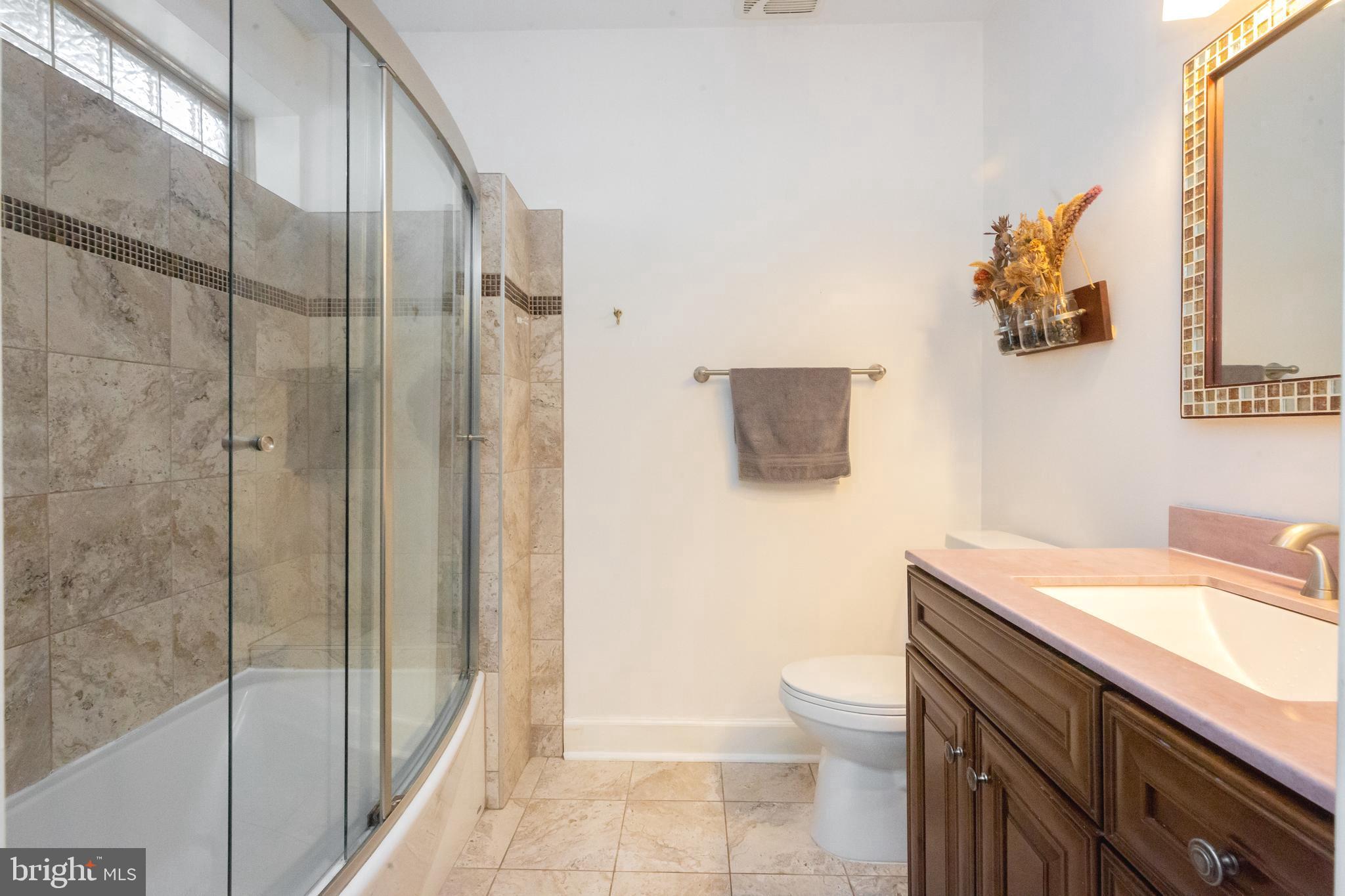 423 18th Street Northeast, Unit 12 Washington, DC 20002 - Photo 22 of 41 a bathroom with a sink a toilet and shower