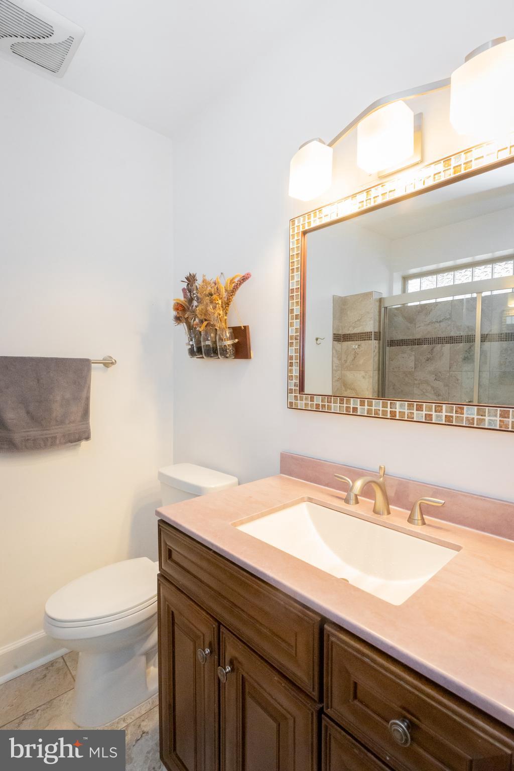 423 18th Street Northeast, Unit 12 Washington, DC 20002 - Photo 23 of 41 a bathroom with a sink a toilet and a mirror