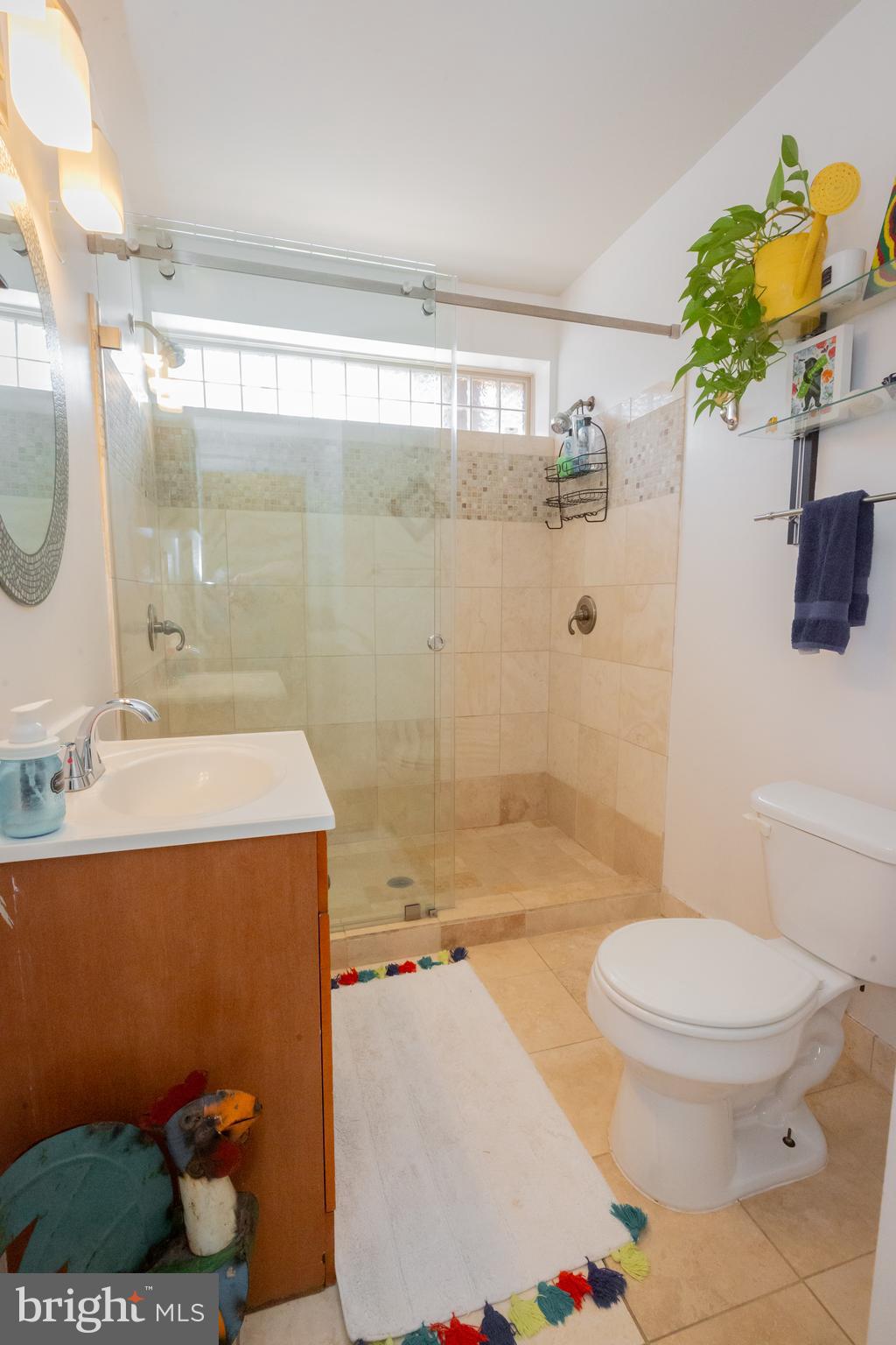 423 18th Street Northeast, Unit 12 Washington, DC 20002 - Photo 33 of 41 a bathroom with a sink a toilet and shower