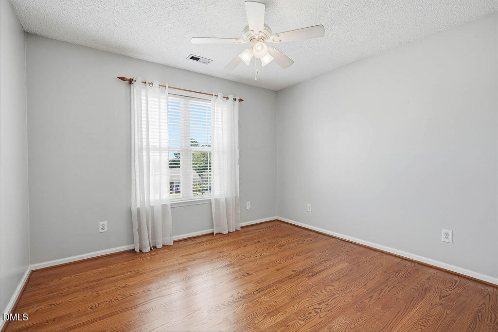 1560 Cane Mill Road Coats, NC 27521 - Photo 28 of 32 wooden floor in an empty room with a window