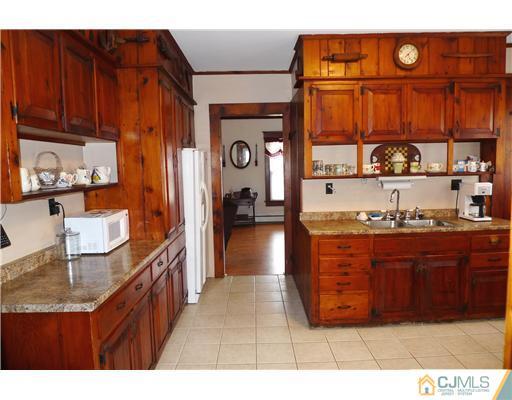 30 Friendship Road Cranbury, NJ 08512 - Photo 4 of 19 a kitchen with stainless steel appliances granite countertop a refrigerator and wooden cabinets