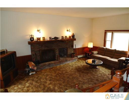 30 Friendship Road Cranbury, NJ 08512 - Photo 8 of 19 a living room with furniture and a fireplace