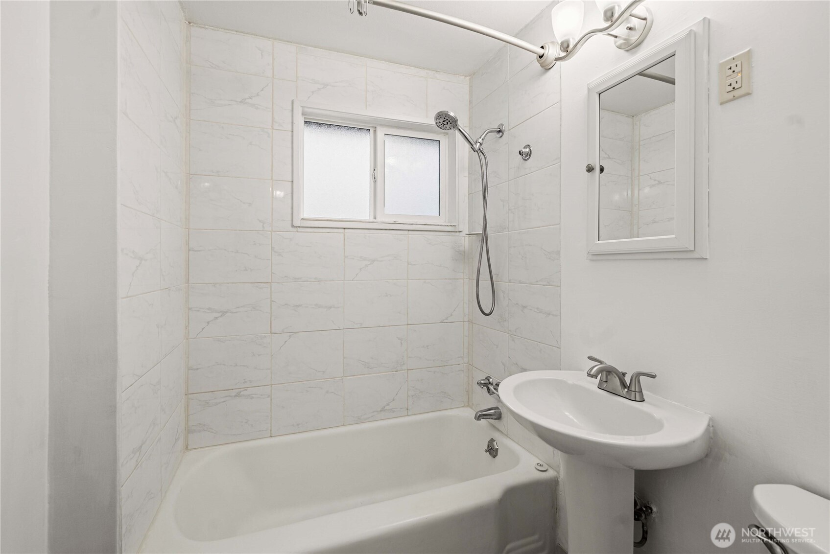 9717 14th Avenue Northwest Seattle, WA 98117 - Photo 11 of 32 a bathroom with a sink a toilet and shower