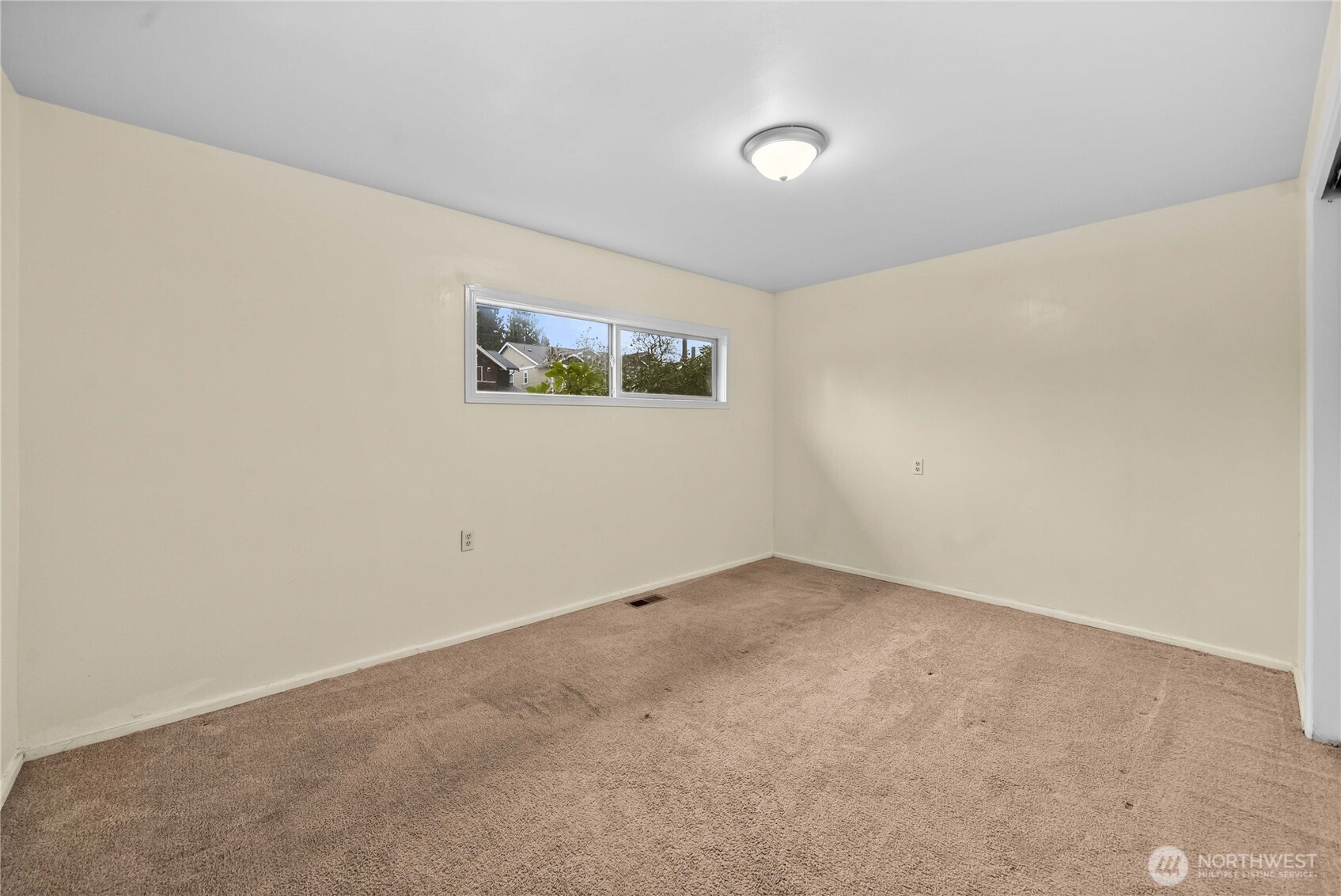 9717 14th Avenue Northwest Seattle, WA 98117 - Photo 13 of 32 an empty room with windows
