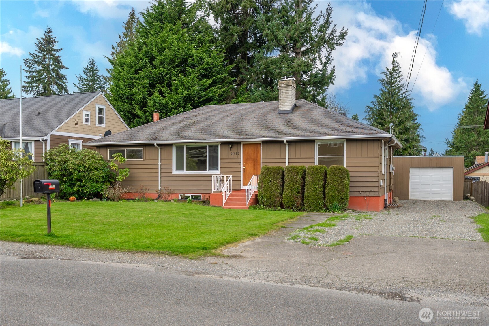 9717 14th Avenue Northwest Seattle, WA 98117 - Photo 2 of 32 a front view of a house with a yard and garage