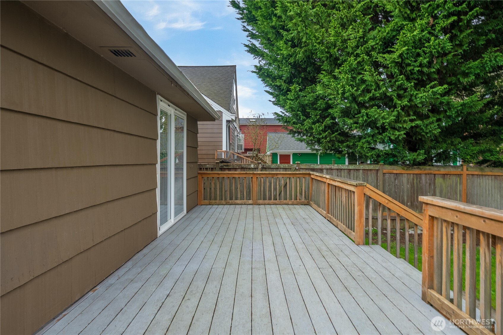 9717 14th Avenue Northwest Seattle, WA 98117 - Photo 22 of 32 a view of balcony with wooden floor and fence