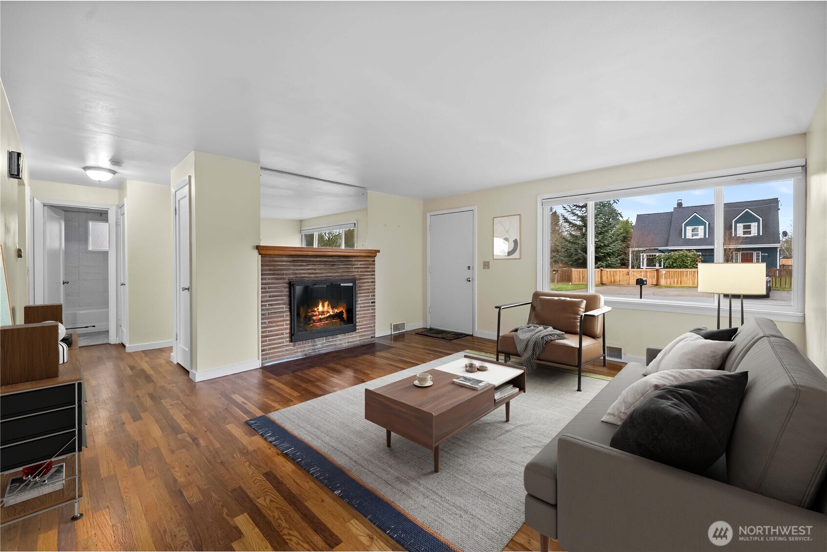 9717 14th Avenue Northwest Seattle, WA 98117 - Photo 3 of 32 a living room with furniture and a fireplace
