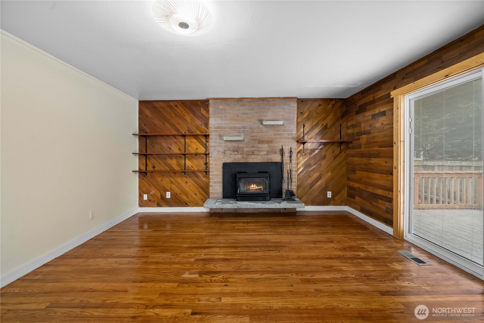 9717 14th Avenue Northwest Seattle, WA 98117 - Photo 10 of 32 a view of empty room with wooden floor and fireplace