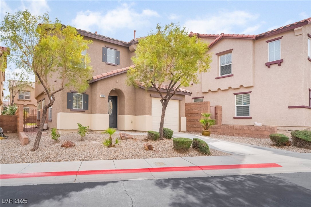 1152 Gecko Road Henderson, NV 89002 - Photo 1 of 32 Mediterranean / spanish home featuring concrete driveway, a tile roof, fence, and stucco siding