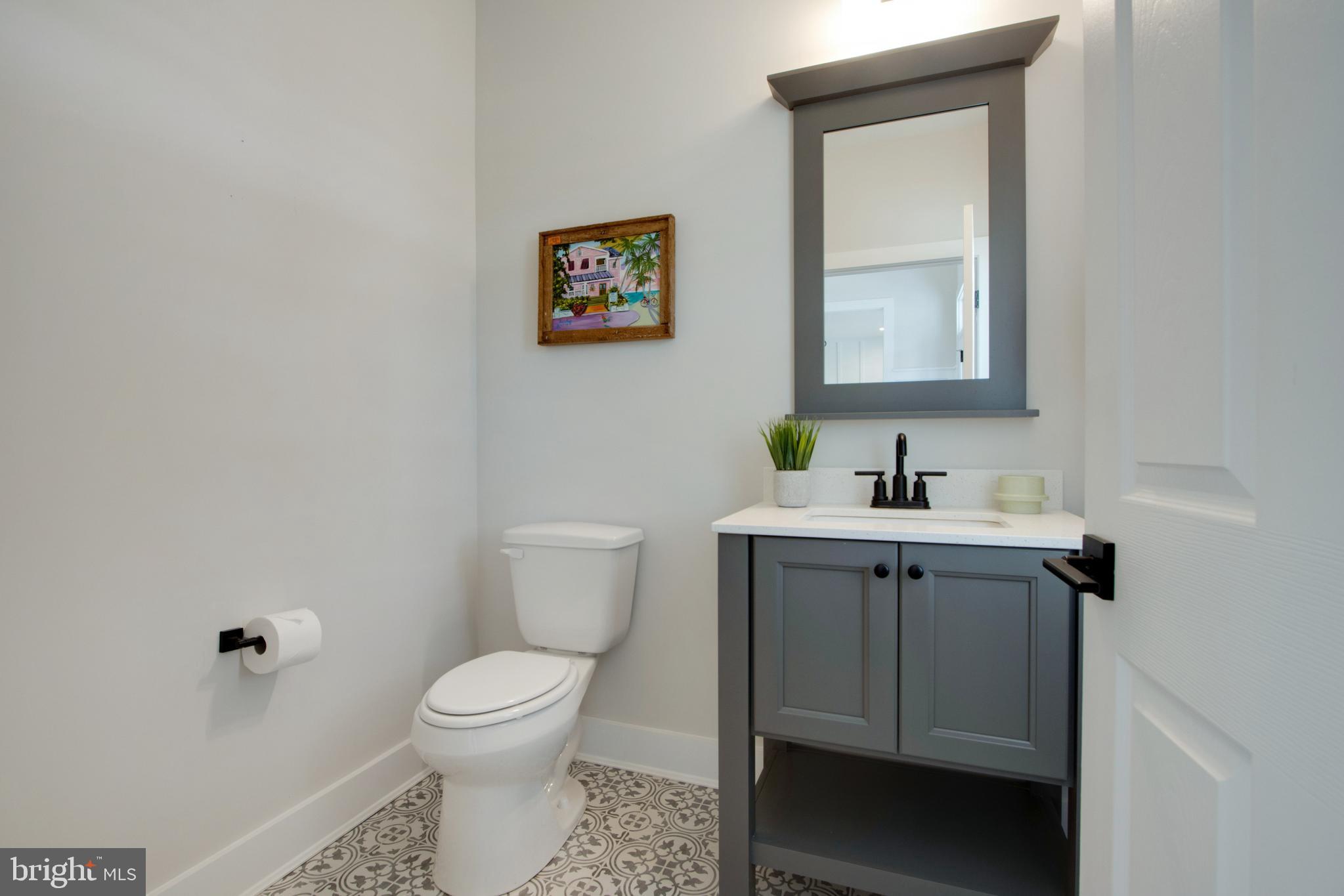 16672 New Road Lewes, DE 19958 - Photo 10 of 55 a bathroom with a toilet sink and mirror